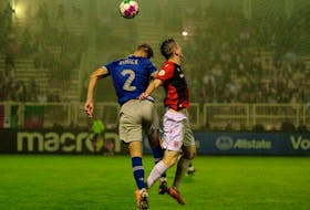 HFX Wanderers' Dan Nimick leaps for a ball against Cavalry FC on a foggy Tuesday night at the Wanderers Grounds. - Canadian Premier League