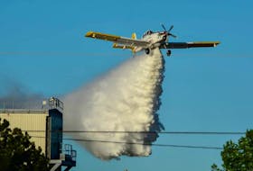A water bomber helps put out a fire at the Lake Utopia Paper Mill in southern New Brunswick. (Brunswick News Archive via Local Journalism Inititiave)