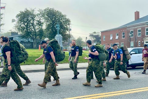 Yarmouth rucksack march participants walk past the Yarmouth Cenotaph while making their way along Main Street on the morning of Sept. 9, headed for the Afghanistan Memorial at Maple Grove Education Centre in Hebron. TINA COMEAU