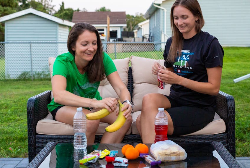 Registered dietitian Sandra Cottreau, left, and her sister, Carrie Gregory, enjoy a post-run snack. Contributed