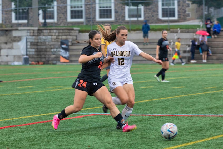 Leah Disipio of the Cape Breton Capers, left, works her way around Chloe Richardson of the Dalhousie Tigers during Atlantic University Sport women’s soccer action at Wickwire Field in Halifax on Friday. Disipio scored three times and led the Capers to a 4-0 victory. CONTRIBUTED/MILANA PADDOCK, DALHOUSIE ATHLETICS