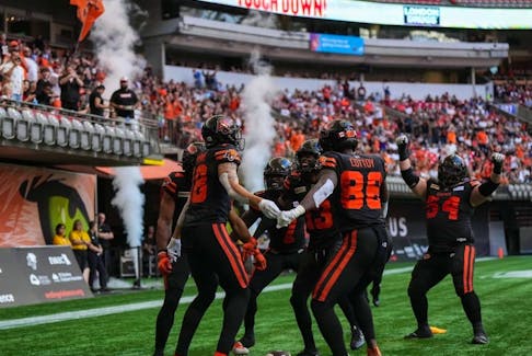 B.C. Lions players celebrate after a first-half touchdown by Justin McInnis during their CFL football game against the Ottawa Redblacks, in Vancouver on Sept. 16, 2023.