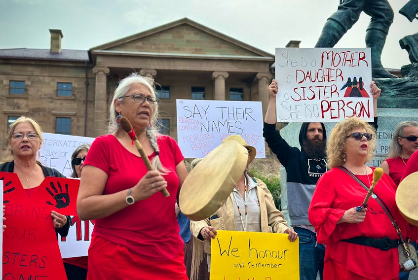 Sarah Jackson, who plays the drum to the left, is the MMIWG2S+ program coordinator with the Native Council of P.E.I. and organizer of a rally held outside Province House on Sept. 18. Thinh Nguyen • The Guardian