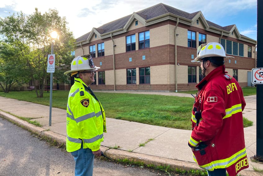 Berwick fire chief Luke Redden (right) and deputy chief George Page talk outside Berwick and District School after a minor fire at the building Monday morning.