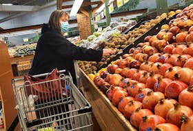 A woman shops for fruit at a supermarket in Ottawa on March 27, 2023. - Patrick Doyle / Reuters