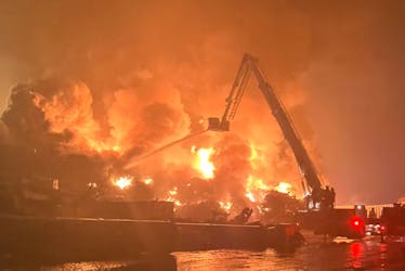 Flames rage from a burning pile of scrap at the AIM Recycling facility in the Port of Saint John on Thursday, Sept 14, 2023. (Margaret Leahey Bailey photo)