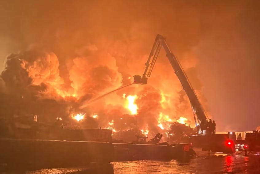 Flames rage from a burning pile of scrap at the AIM Recycling facility in the Port of Saint John on Thursday, Sept 14, 2023. (Margaret Leahey Bailey photo)