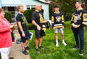 Sidney Crosby shares a laugh with some Pittsburgh Penguins fans after personally delivering their season tickets on Monday. - Pittsburgh Penguins