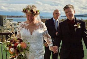 Vera Teschow, left, and Tatiana Kachira celebrate their wedding on Teschow's stepfather’s condo roof top in Charlottetown in 2022. Post-tropical storm Fiona forced the couple to change venues when it caused heavy damage to the property where they originally planned to get married. Contributed