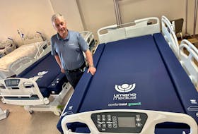 Willard D’Eon, chair of the Yarmouth County Hospice Society, stands with two cuddle beds the society recently purchased for the hospice wing of the Yarmouth Regional Hospital. TINA COMEAU PHOTO