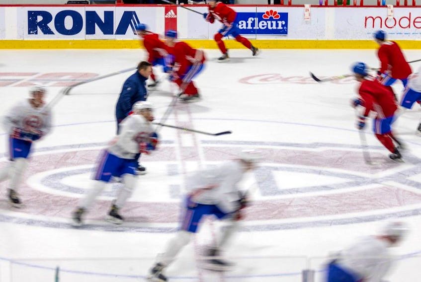 Canadiens prospects skate around coach Jean-François Houle during rookie camp on Sept. 14. Some of those players will be pushing veterans for roster spots this season, Stu Cowan writes.