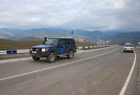 By Felix Light NEAR KORNIDZOR, Armenia (Reuters) - One man was hoping to find his son, another was looking for his father. In a long, cold vigil at Armenia's border with Azerbaijan on Thursday, a