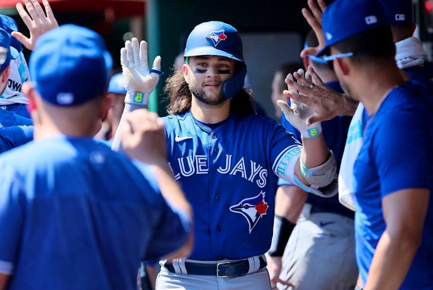 Bo Bichette #11 of the Toronto Blue Jays celebrates with teammates after hitting a home run against the Cincinnati Reds at Great American Ball Park on August 20, 2023