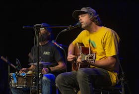 The Town Heroes' Michael S. Ryan (right) plays guitar and sings as drummer Bruce Gillis pounds away during an acoustic set at the Marigold in Truro on Sept. 15, Musicians Zach MacLean and Tori Cameron (not pictured) also joined in on the fun before the storm. Nick Gaines