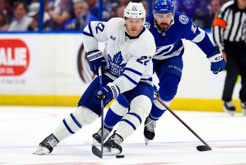 Maple Leafs defenceman Jake McCabe (left) and Nicholas Paul of the Tampa Bay Lightning fight for the puck during  Game 4 of the first round of the 2023 Stanley Cup playoffs at Amalie Arena on April 24, 2023 in Tampa. 