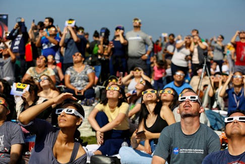 By Will Dunham WASHINGTON (Reuters) - Millions of people in the Americas will be in a position to witness an astronomical treat on Oct. 14 with a solar eclipse in which - weather permitting - the moon
