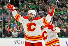 Calgary Flames center Jonathan Huberdeau (10) celebrates a goal scored by left wing Nick Ritchie (not pictured) against the Dallas Stars during the first period at the American Airlines Center. 
