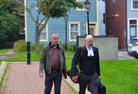 Former P.E.I. resident Jan (John) Vanderzwaag, left, and his lawyer Brian Ross, walk into P.E.I. Supreme Court on Sept. 12, 2023, for a trial on two counts of sexual assault. On Sept. 21, 2023, a jury found Vanderzwaag not guilty of the charges.