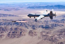 An MQ-9 Reaper remotely piloted drone aircraft fires a Hellfire missile during testing on Aug. 30 in the United States.