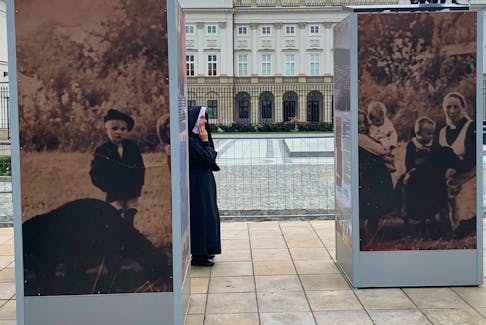  A nun views a display about the Ulma family outside the presidential palace in Warsaw. Photo by Ryan Tumilty