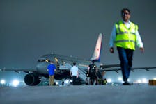 Prime Minister Justin Trudeau's plane is seen on the tarmac after being grounded due to a technical issue following the G20 Summit in New Delhi, India. 