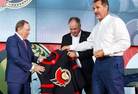 Sen's owner Michael Andlauer receiving a Sens jersey from NHL Commissioner Gary Bettman and Sens GM Pierre Dorion Friday. 
