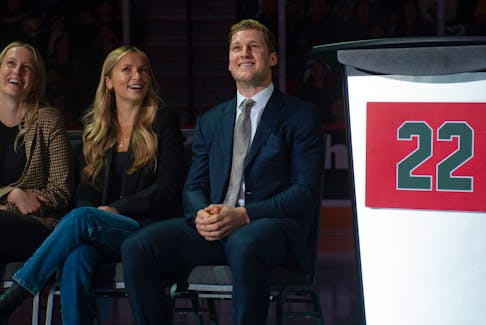 NHL superstar Nathan MacKinnon smiles as he watches a video tribute from Sidney Crosby along with his sister Sarah MacKinnon (left) and girlfriend Charlotte Walker during MacKinnon's Halifax Mooseheads jersey retirement ceremony on Friday, Sept. 22, 2023. 
Ryan Taplin - The Chronicle Herald