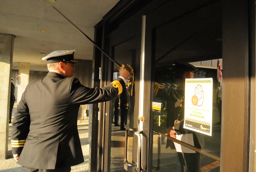 HMCS Cabot naval reserve unit commanding officer, Cmdr. David Botting, uses the base of his ceremonial sword to tap on the glass of the main doors of St. John’s City Hall to request Freedom of the City be bestowed upon them by St. John’s Mayor Danny Breen.  -Photo by Joe Gibbons/SaltWire