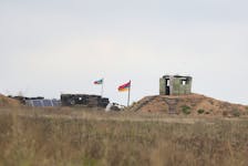 By Felix Light NEAR KORNIDZOR, Armenia (Reuters) - Russia said that Armenian fighters in the breakaway region of Nagorno Karabakh had started to give up arms as some humanitarian aid reached the