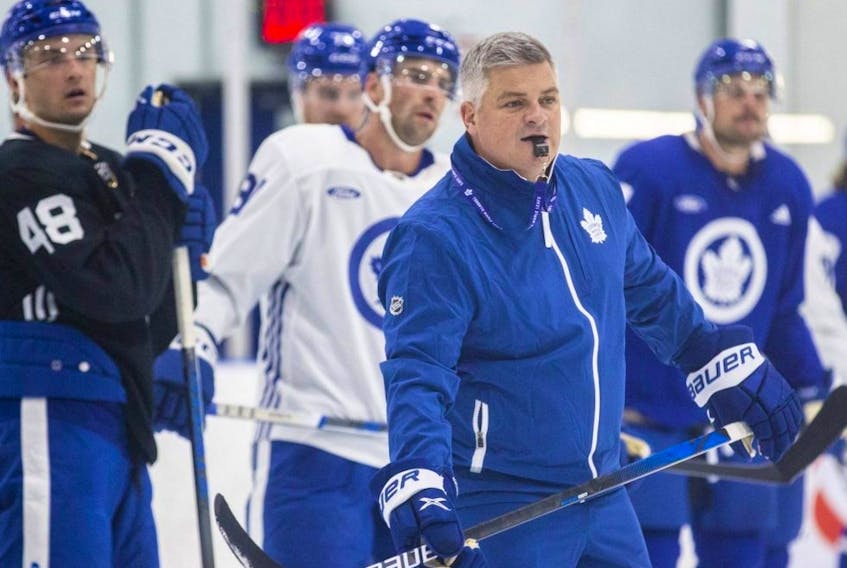Maple Leafs head coach Sheldon Keefe runs a drill during training camp at the Ford Performance Centre in Toronto, Thursday, Sept. 21, 2023.