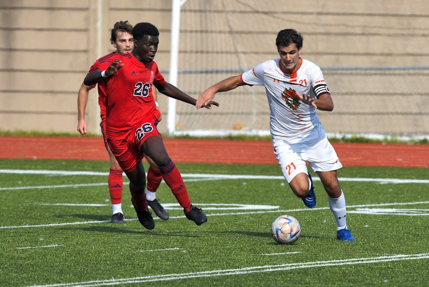 Ze Cunha of the Cape Breton University men’s soccer team takes the ball past Acadia player Nathan Amoah-Gyekye as the Capers blanked the hometown Axemen 3-0 in Atlantic University Sport soccer. Cunha was named player of the game for the undefeated Capers (5-0-0) in the match. Contributed