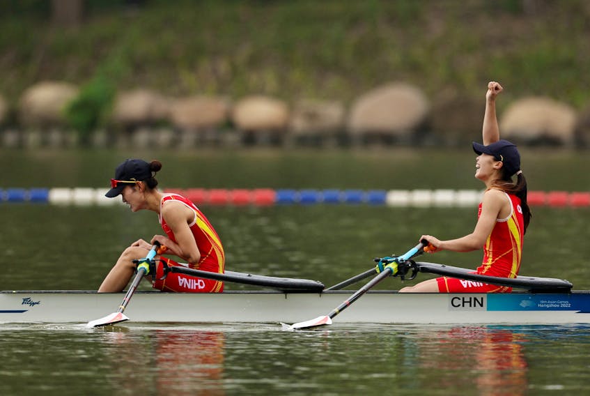 HANGZHOU, China (Reuters) - Asian Games hosts China claimed the first gold of the continental sporting showpiece on Sunday when Zou Jiaqi and Qiu Xiuping won the lightweight women's doubles sculls