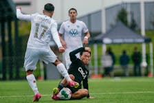 HFX Wanderers forward Wesley Timoteo tries to send a ball past sliding Vancouver FC defender Kadin Chung during Canadian Premier League action Saturday afternoon in Langley, B.C. - Canadian Premier League