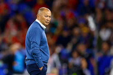 By Nick Mulvenney LYON, France (Reuters) - Eddie Jones said he remained 100% committed to the task of turning Australian rugby around after his young side were thrashed by Wales to move to the brink