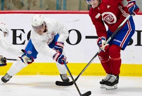 Canadiens' Brendan Gallagher, left, and Justin Barron battle for the puck during Habs training camp in Brossard last week.