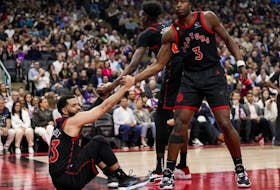 Fred VanVleet of the Toronto Raptors is helped up by teammates Chris Boucher and O.G. Anunoby during the 2023 Play-In Tournament against the Chicago Bulls at the Scotiabank Arena on April 12, 2023 in Toronto, Ontario, Canada.  
