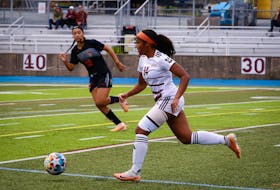 Capers striker Alliyah Rowe watches as Huskies defender Alexa Ikejiani carries the ball up the field on Sunday. Rowe scored all four goals in a 4-0 win for the visiting Capers in Atlantic University Sport soccer action. Contributed/Eduardo Ibarra