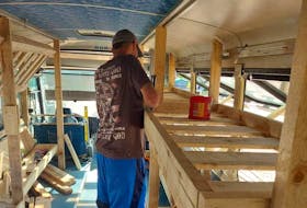 Keith Ivany works on what he calls a freedom bus, a 16-bunk shelter that will provide homeless people in Charlottetown with a place to stay. Contributed