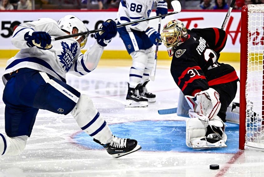 The Toronto Maple Leafs' Max Domi is unable to get a clean shot on the Ottawa Senators' Anton Forsberg during third period in preseason NHL hockey action in Ottawa, on Sunday, Sept. 24, 2023.