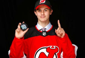 Jack Hughes poses for a portrait after being selected first overall by the New Jersey Devils at the 2019 NHL Draft in Vancouver.