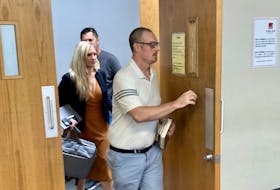 Matthew Douglas Moriarty leaves Dartmouth provincial court Tuesday with lawyer Jennifer MacDonald after appearing on six charges of voyeurism. Moriarty, a teacher, is accused of using his cellphone to record videos of five females in a washroom at Abenaki Aquatic Club without their consent.