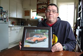 Jason Gillis of Sydney holds a photo of the 1977 Pinto that was taken in 1997 after his best friend Aaron Tuck bought it. After the tragic death of Tuck and his family in 2020, Gillis was gifted the Pinto to restore it in the Tuck family's memory. NICOLE SULLIVAN/CAPE BRETON POST