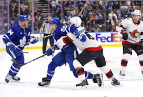 Maple Leafs' Tyler Bertuzzi battles with Ottawa Senators' Jakob Chychrun during  pre-season action in Toronto on Monday, Sept. 25, 2023. 