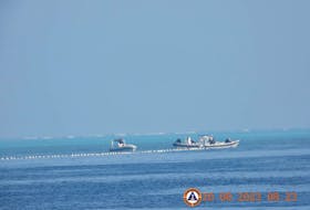 MANILA (Reuters) - The Philippine coastguard said on Tuesday that its Chinese counterpart had already removed remnants of a floating barrier that blocked Filipino fishers from entering a lagoon at a