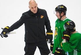 Vancouver Canucks head coach Rich Tocchet gives some direction to forward J.T. Miller during Tocchet's first practice with the team on Jan. 23 at Rogers Arena.