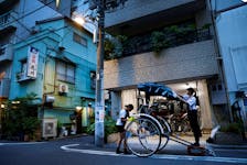 By Mariko Katsumura and Issei Kato TOKYO (Reuters) - Photo essay: Rickshaw puller Yuka Akimoto breathlessly dashes down the streets of Tokyo under a scorching summer sun, two French tourists enjoying