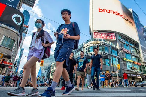 Pedestrians in downtown Toronto. Canada's population grew by 1.1 million people last year, Statistics Canada says.
