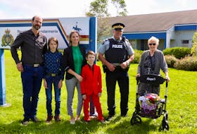 On Sept. 19, family and friends gathered to witness Finn Chiasson (in the red suit) receive thanks from the RCMP for helping to name one of the 12 new foals born this spring. Pictured are, from left, Todd Chiasson, Ethan Chiasson, Jennifer Sutherland-Chiasson, Finn Chiasson, Staff Sgt. David Ferguson, of the West Hants RCMP detachment, and Cay Wynn, the mother of the late Const. David Wynn.