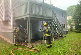Kentville firefighters prepare to enter a burning home on Lacewood Drive in the town early Wednesday morning. Two occupants were taken to the home for assessment of smoke inhalation.