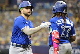 Blue Jays' Bo Bichette (left) is greeted at home by teammate Vladimir Guerrero Jr. after Bichette's ninth-inning home run agains the Tampa Bay Rays at Tropicana Field on Sept. 24, 2023 in St Petersburg.